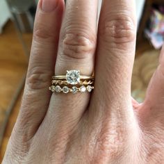 a woman's hand with two different rings on her left and the other one has a diamond in it