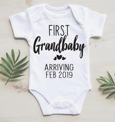 a white baby bodysuit with the words'first grandbaby arriving feb 2019 on it