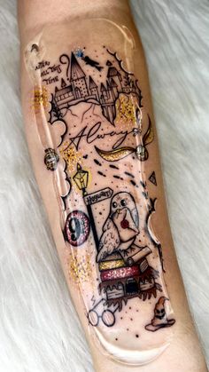 a person with a tattoo on their leg that has an image of a castle in it