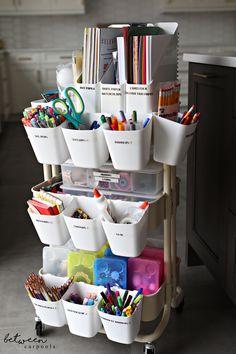 a cart filled with lots of different colored pencils and markers