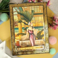 an art deco painting on display next to flowers