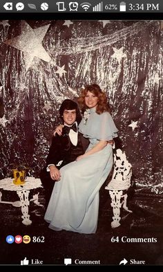 an old photo of two people sitting on a chair in front of a star backdrop