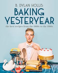 a man sitting at a table in front of a cake