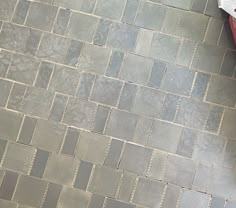 a red bench sitting on top of a tiled floor