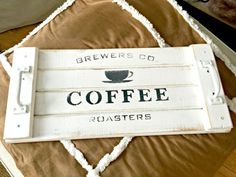 a sign that says brewers co coffee roasters on top of a bed with pillows