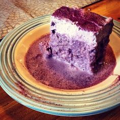 a piece of cake sitting on top of a plate covered in purple powdered sugar