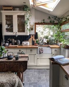 a kitchen filled with lots of counter top space next to a wooden table and chair