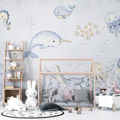 a child's room decorated in pastel colors with sea animals and marine creatures