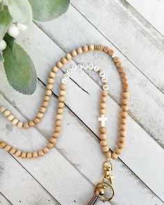 a wooden rosary with a cross on it and a keychain attached to it