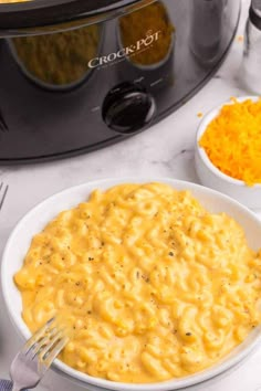 a bowl of macaroni and cheese next to an instant pot