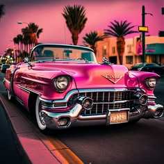 an old pink car is parked on the side of the road with palm trees in the background