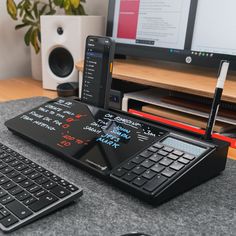 a phone sitting on top of a desk next to a keyboard