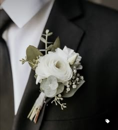 a man in a suit and tie with a boutonniere on his lapel