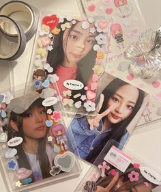 two girls are surrounded by various stickers and other items that include scissors, hair clips, and buttons