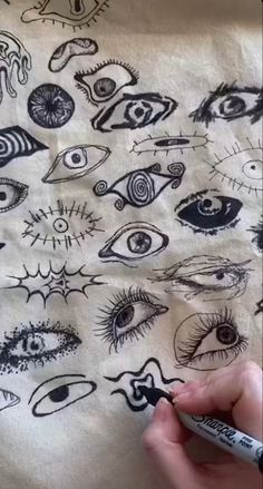 someone is drawing an eye pattern on a t - shirt