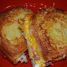 a grilled cheese sandwich cut in half on a red plate