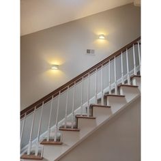 a stair case with two lights on each side and an air vent above the stairs