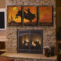 a living room with a fire place and paintings on the wall