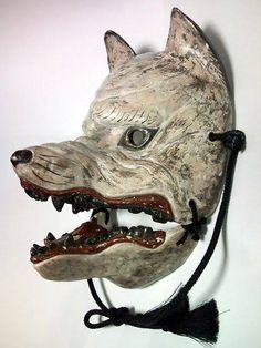 an animal mask is hanging on the wall