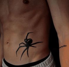 a man with a spider tattoo on his stomach