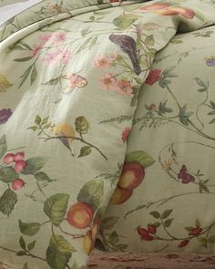 the comforter is made up with flowers and birds