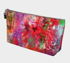 a multicolored zipper bag with an abstract design on the front and bottom side