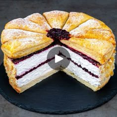 an image of a cake that is cut in half and served on a black plate