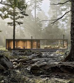 a house in the woods surrounded by rocks and trees with lots of light shining on it