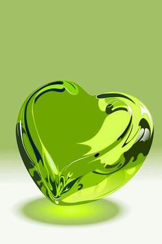 a green heart shaped object sitting on top of a table