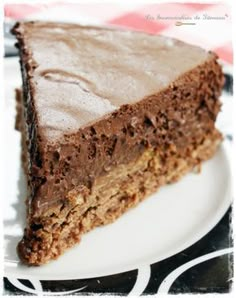 a piece of chocolate cake sitting on top of a white plate