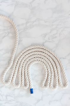 a white rope with blue ends on a marble surface