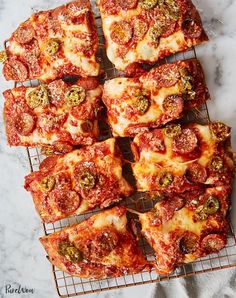 several slices of pizza sitting on top of a cooling rack