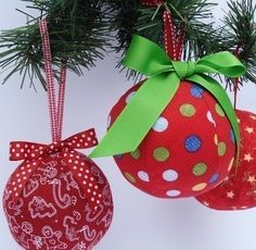 two christmas ornaments hanging from a tree