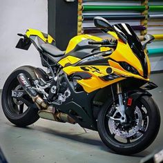 a yellow and black motorcycle parked in a garage