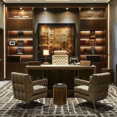 an office with two chairs and a desk in front of a book shelf filled with books