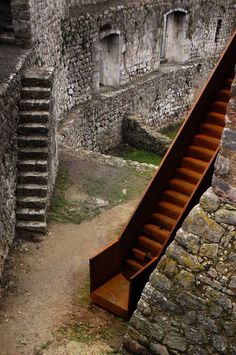 an old staircase leading up to a stone building