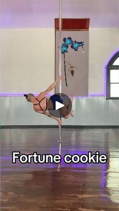 a woman is doing pole dancing on the floor