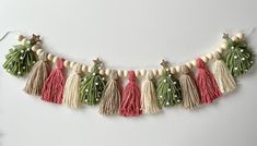 the tasselled garland is decorated with green and red beads