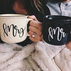 two people holding coffee mugs with the words mr and mrs painted on each one