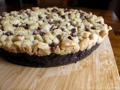 a chocolate chip pie sitting on top of a wooden cutting board