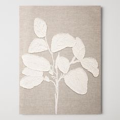 a canvas with white leaves on it