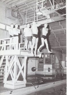 three men standing on top of a boat in the water