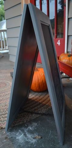 an image of a house with pumpkins on the front porch and side walk way