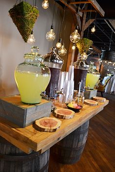 a wooden table topped with lots of drinks