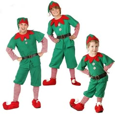 two children dressed in elf costumes standing next to each other, both wearing red and green striped socks