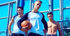 three men are holding a basketball in front of a blue fence with the words raglan t - shirt on it