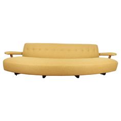 a yellow couch sitting on top of a white floor