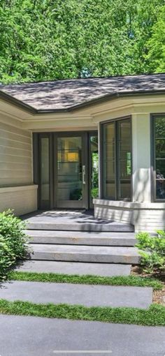 a small house with steps leading to the front door