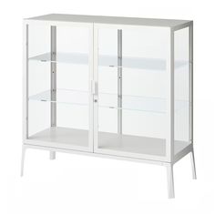 a white cabinet with glass doors and two shelves on one side, in front of a white background