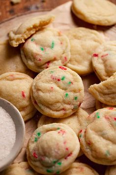 cookies with sprinkles and powdered sugar on a cutting board